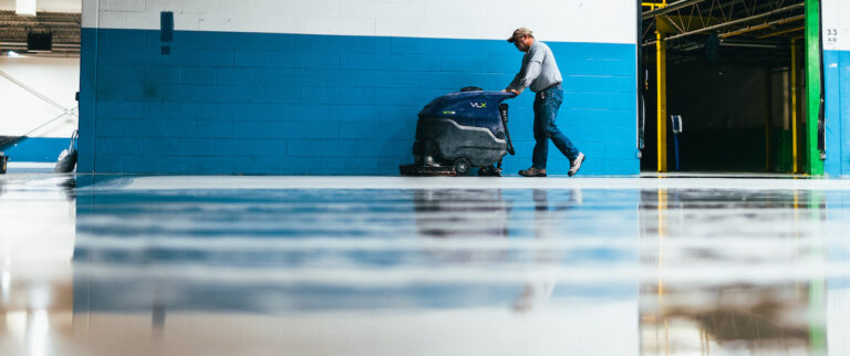 Paramount Industrial Services employee polishing concrete floors.